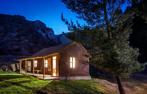 a small cabin in the mountains at night at Colca Lodge Spa & Hot Springs in Yanque
