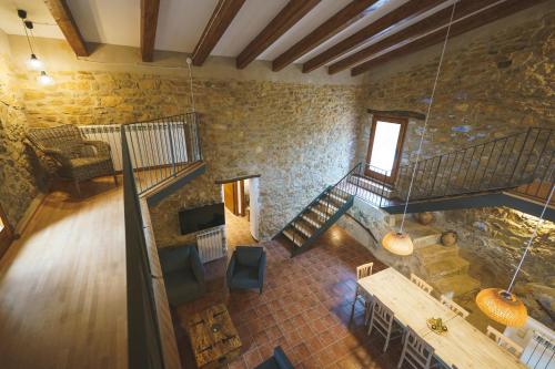 an overhead view of a room with stairs and a stone wall at Casa rural Mas del Serranet in Horta de San Joan
