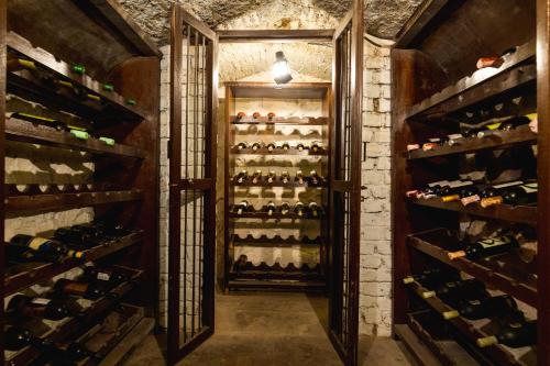 a wine cellar with a bunch of wine bottles at Fort JadhavGADH -A GADH Heritage Hotel in Pune