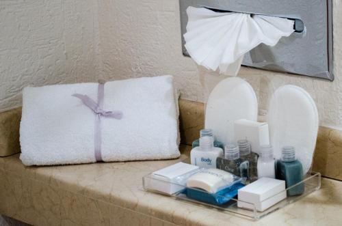 un bagno con cuscino, specchio e asciugamano di Mesón Ejecutivo Guadalajara Minerva - Av México a Guadalajara