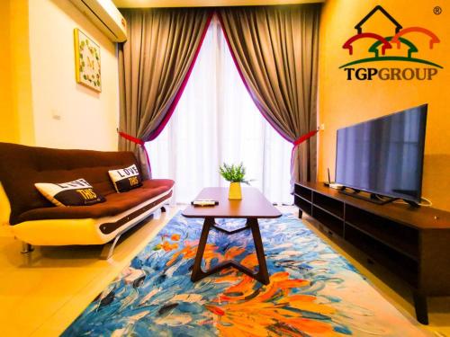 a living room with a couch and a tv and a table at Legoland D'PRISTINE Apartment By TGP in Nusajaya