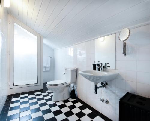 a bathroom with a white toilet and a sink at OportoHouse in Porto