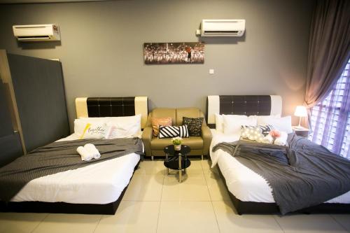 Zimmer mit 2 Betten und einem Sofa in der Unterkunft Palazio Apartment Mount Austin By The one in Johor Bahru