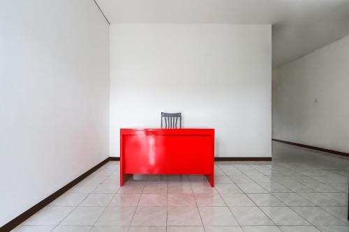 a red cabinet in a room with white walls at Hotel O Bungo Guest House in Muarabungo