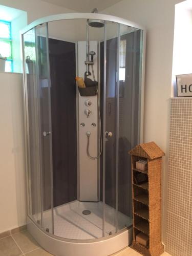 a shower with a glass enclosure in a bathroom at Maison familiale Centre France in Meunet-sur-Vatan