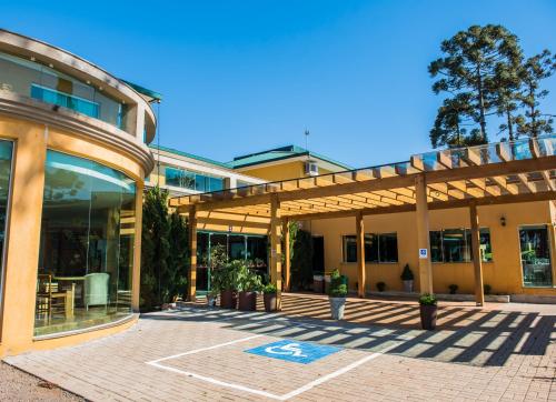 an outside view of a building with a patio at Lagoa Parque Hotel in Lagoa Vermelha