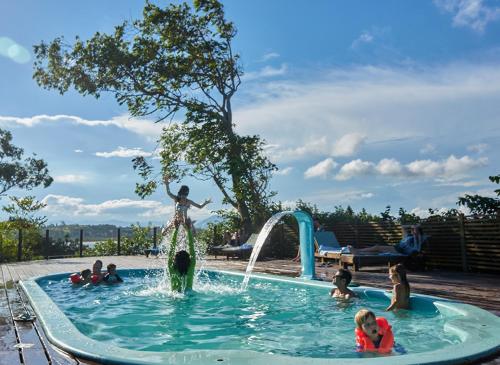 a group of people in a pool with a fountain at Pousada Mevlana Garden in Barra de Ibiraquera
