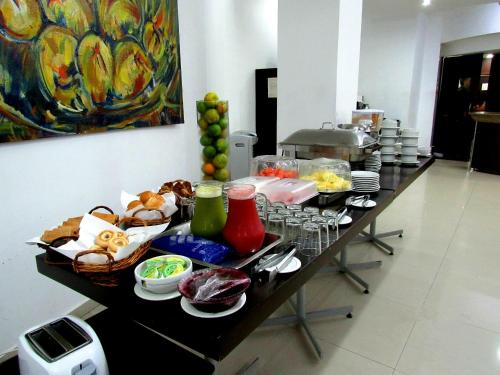 a table with food on it in a kitchen at Hotel Plaza Las Américas Cali in Cali