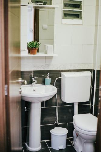 a bathroom with a sink and a toilet at White & Wood in Bitola