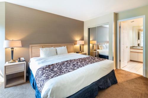 a hotel room with a large bed and a bathroom at The Ironwood on Blueberry Hill in Whistler