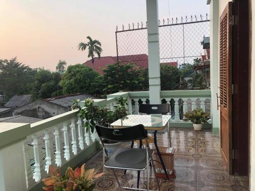 a balcony with a table and chairs on a balcony at Bach Dai Dung Hotel in Ha Tinh