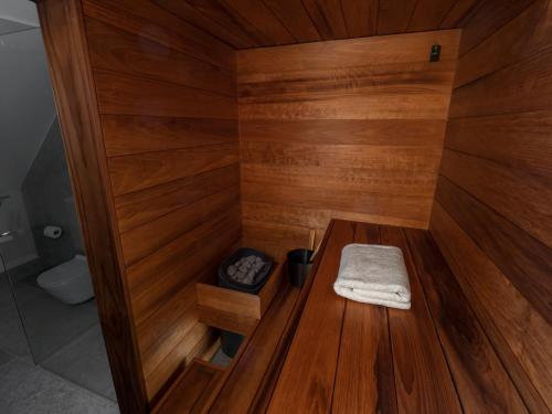 a sauna with a wooden floor and a wooden table at Boutique Hotel Rosenplänter in Pärnu