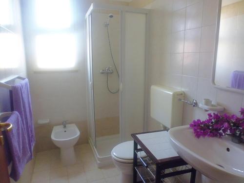 a bathroom with a shower and a toilet and a sink at Residence Rivamare Ugento in Torre Mozza