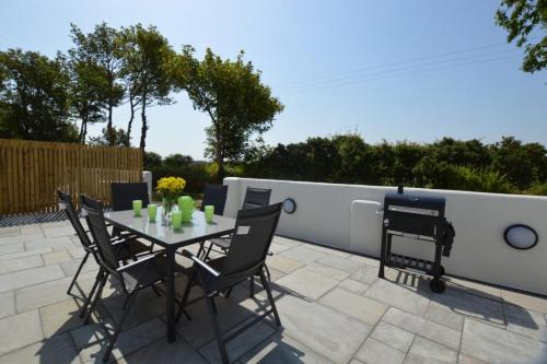 a table and chairs sitting on a patio at Sunnyside Barn in Truro