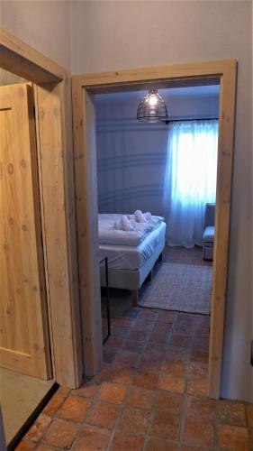 a bedroom with a bed and a door leading into a room at Ořechový dvůr in Velké Nepodřice