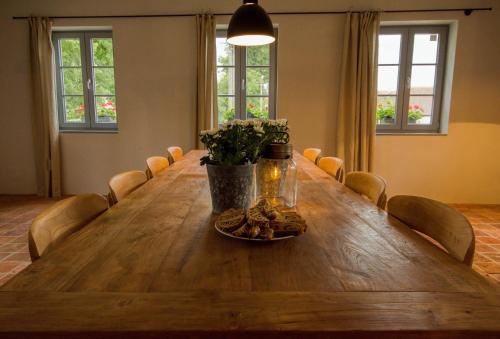 a long wooden table in a room with chairs at Ořechový dvůr in Velké Nepodřice