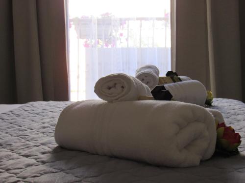 a pile of rolled towels on a bed at amurimè in Porto Empedocle