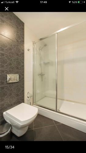 a bathroom with a toilet and a glass shower at CTS Elysium Residence Taksim in Istanbul