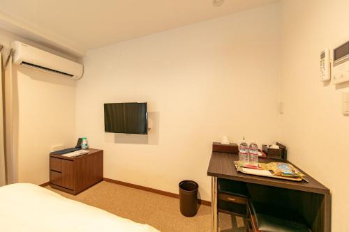 a room with a bed and a desk and a tv at Stay SAKURA Nihonbashi / Vacation STAY 51029 in Osaka