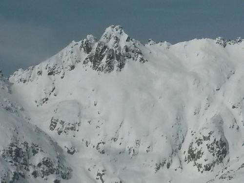a mountain covered in snow on top at Artesano II in Navarredonda de Gredos