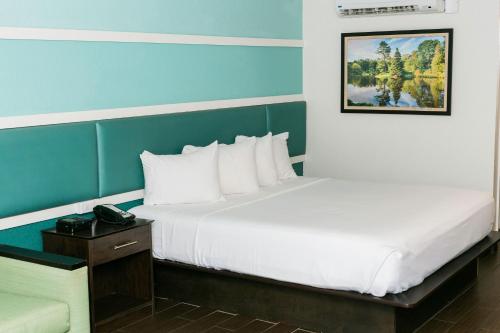 a hotel room with two beds and a telephone at The Flagler Inn - Saint Augustine in Saint Augustine