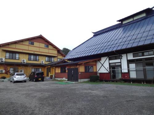 a building with solar panels on the side of it at Hanasaku Onsen Yoshiyaso in Katashina