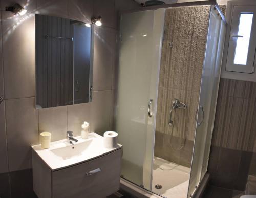 a bathroom with a shower and a sink and a shower at Sofia's view in Amaliapoli
