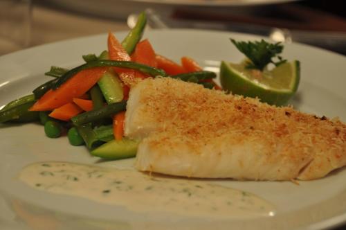 a plate of food with fish and vegetables on it at Hôtel Mechouar Plaza in Essaouira