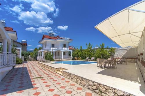 a villa with a swimming pool and a house at Villa Ekin in Fethiye