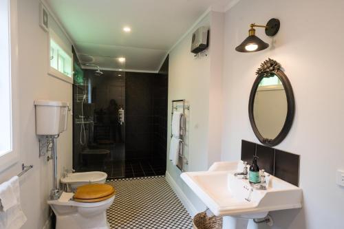 a bathroom with a sink and a toilet and a mirror at York House in Russell