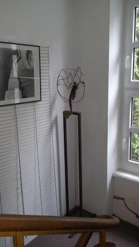 a statue of a bird on a stand in a room at Animrumru in Warsaw