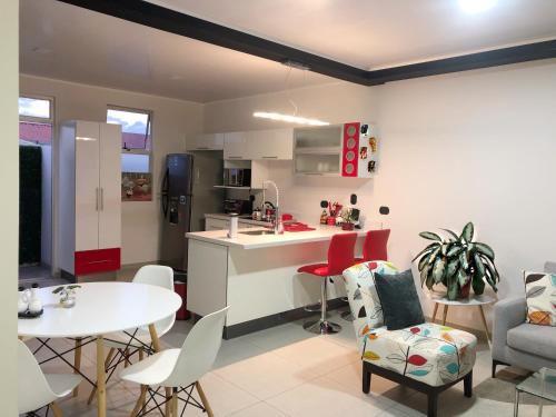 a kitchen and living room with a table and chairs at Costa Rica San Jose Full and Comfortable Apartament Pinares Curridabat in San José