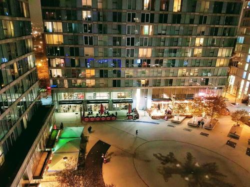 a large building with a courtyard in front of it at Central Milton Keynes hub one bedroom secured apartment in Milton Keynes