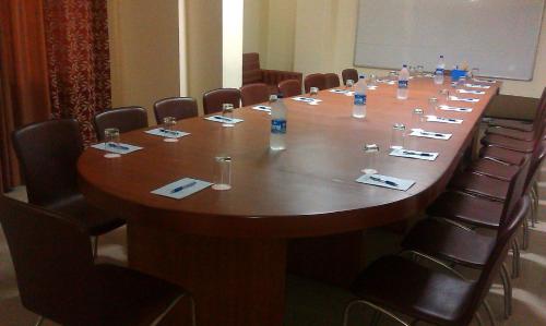 a long table in a room with chairs around it at Hotel Maiden Residency in Ghaziabad
