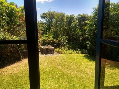 a view of a yard from a window at Casa de praia na beira do mar in Florianópolis