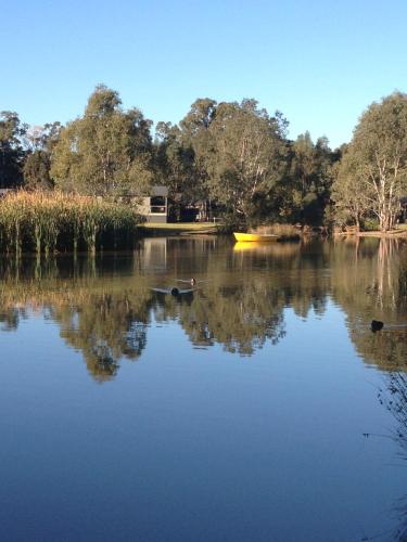 a person in a boat on a lake at Tasman Holiday Parks - Moama on the Murray in Moama