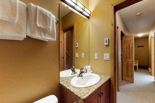 a bathroom with a sink and a mirror at Silver Tip 6 in Big White