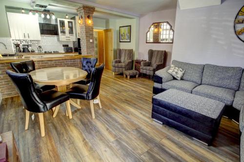 a living room with a couch and a table at The Old Joiner's Shop in Whitby