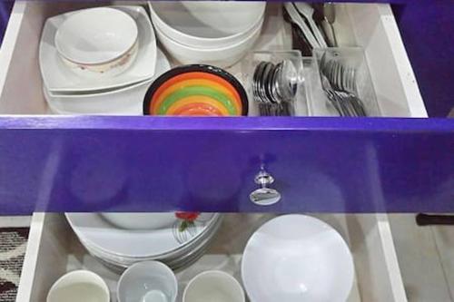 a box filled with plates and bowls and utensils at Tagaytay Suite 2 in Tagaytay