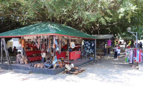 a market with a green tent with shoes and other items at Nadi Fancy Hotel in Nadi