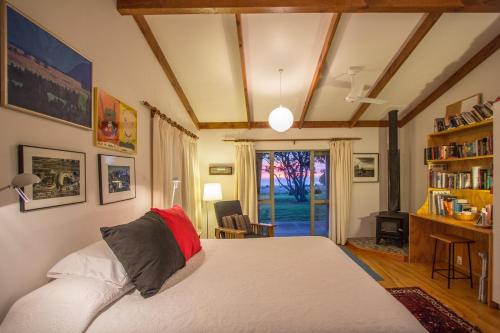 a bedroom with a bed and a book shelf at Lansdowne Farm in Hawkeswood