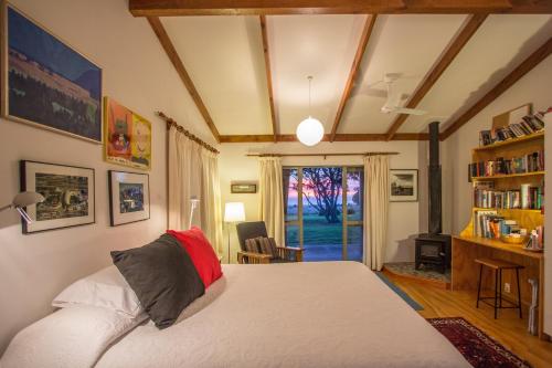 a bedroom with a bed and a book shelf at Lansdowne Farm Lodge in Hawkeswood