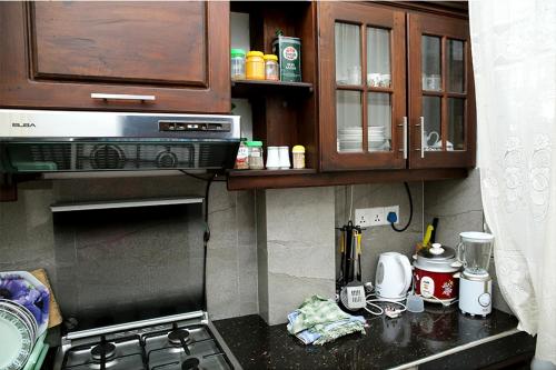 a kitchen with a stove and a counter top at Shan Star Weligama in Weligama