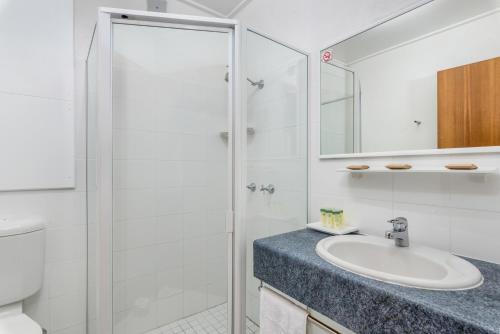 a bathroom with a sink and a shower at Tudor Inn Newcastle in Newcastle