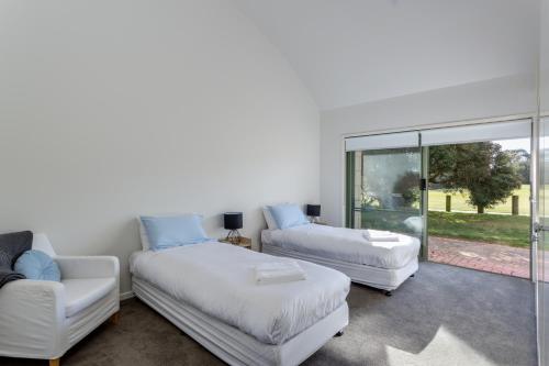 a living room with two beds and a couch at Cape Schanck Golf Getaway in Cape Schanck