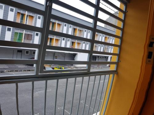 a window in a building with a view of a street at Baoyousongsong in Kampar