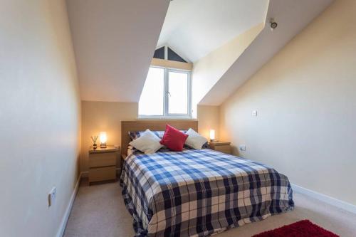 a bedroom with a bed in a attic with a window at Cruisers Haven in Southampton