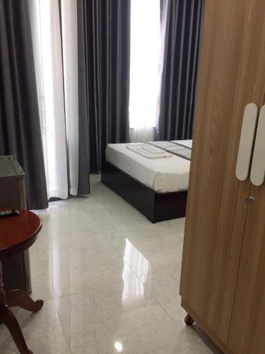 a hotel room with a bed and a window at Khánh An Hotel in Nha Trang
