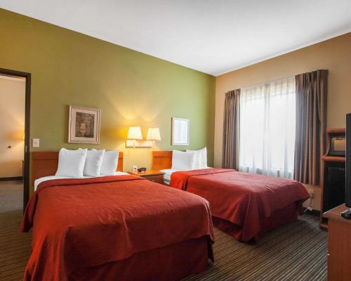 a hotel room with two beds and a window at Quality Inn Joplin I-44 in Joplin