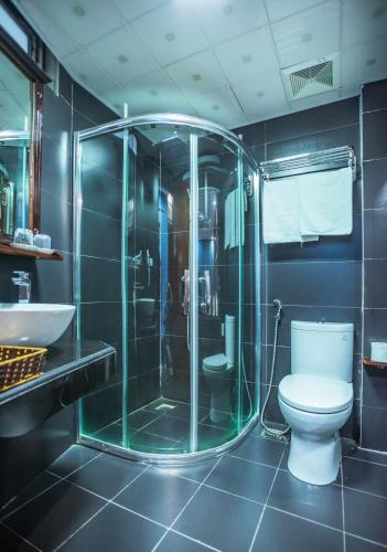 a bathroom with a shower and a toilet and a sink at SAPA FULL HOUSE HOTEL in Sapa